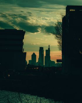 A Silhouette of the Philadelphia Skyline Between Two Dark Silhouetted Buildings