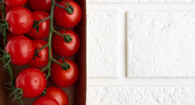 Cherry tomatoes on a branch in eco-friendly packaging