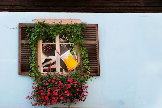 Background concept for presentation, with a stork in front of window drinking beer. With copy space.