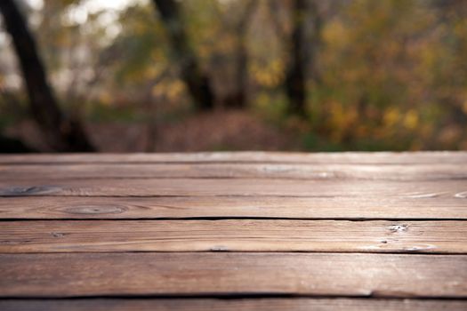 Empty wooden table autumn nature bokeh background with a country outdoor theme,Template mock up for display of product Copy space