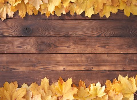 Autumn leaves frame on wooden background top view Fall Border yellow and Orange Leaves vintage wood table Copy space for text