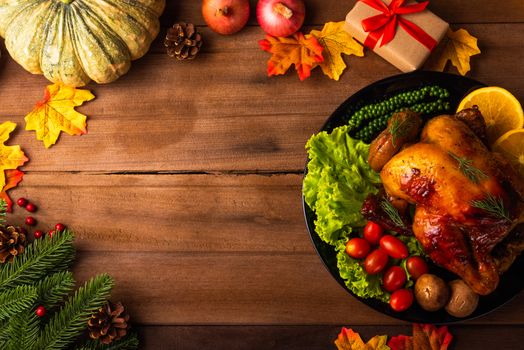 Thanksgiving roast turkey or chicken and vegetables, Top view Christmas dinner feast food decoration traditional homemade on wooden table background, Happy thanksgiving day of holiday concept