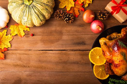 Thanksgiving roast turkey or chicken and vegetables, Top view Christmas dinner feast food decoration traditional homemade on wooden table background, Happy thanksgiving day of holiday concept