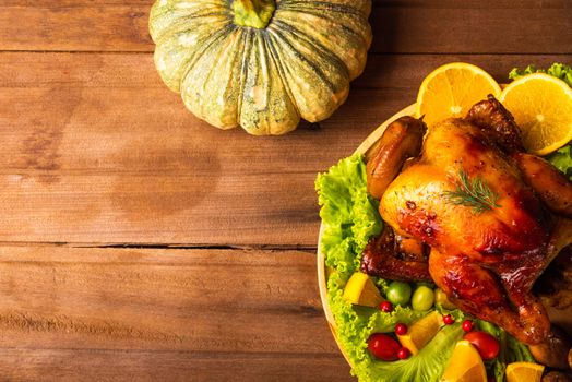 Thanksgiving roasted turkey or chicken and vegetables, Top view Christmas dinner feast food decoration traditional homemade on wooden table background, Happy thanksgiving day of holiday concept