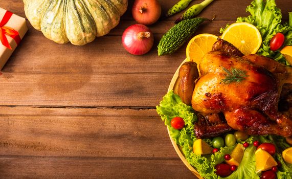 Thanksgiving roasted turkey or chicken and vegetables, Top view Christmas dinner feast food decoration traditional homemade on wooden table background, Happy thanksgiving day of holiday concept