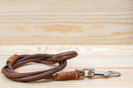 Pet leather leashes on wooden background