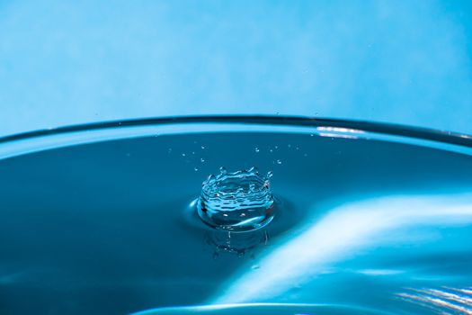 Abstract an outbreak of crown water.Splash of water close up.Frozen water drop photographed at high speed.Slow dripping of liquid with air bubbles.Nature backgrounds or Wallpaper.Frozen liquid splash