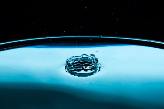 Abstract an outbreak of crown water.Splash of water close up.Frozen water drop photographed at high speed.Slow dripping of liquid with air bubbles.Nature backgrounds or Wallpaper.Frozen liquid splash