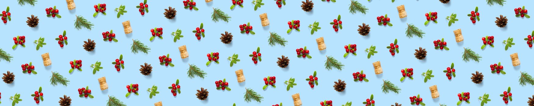 christmas background with pine cone, wine cork, pine twig and lingonberry. christmas background on blue backdrop