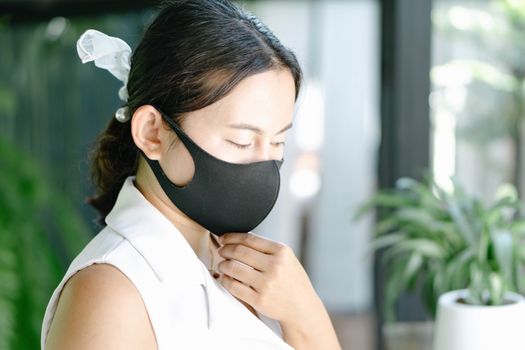 Closeup woman wearing face mask for protect air polution or virus covid 19 , health care and medical concept