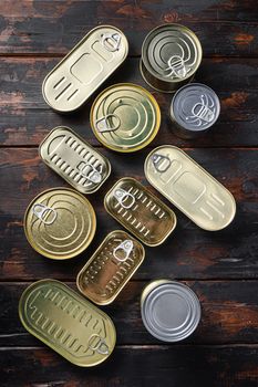 Tin cans food set top view on dark wood rustic background top view.