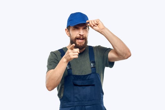 Worker man uniform delivery service emotions studio light background. High quality photo