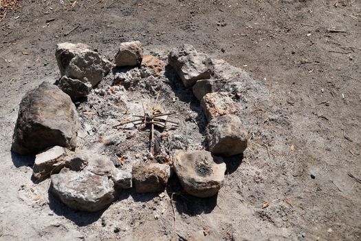 an extinct bonfire fenced with stones