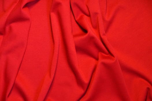red draped material, texture for red background.