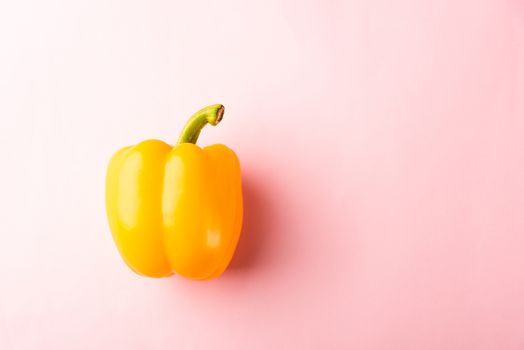 Close up above top view of raw yellow bell peppers on pink pastel background, fresh organic vegetables, Healthy lifestyle diet food concept