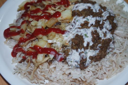Delicious traditional dish of rice with potato fries and cereals with red ketchup. Food background with copy space for text and advertisements.
