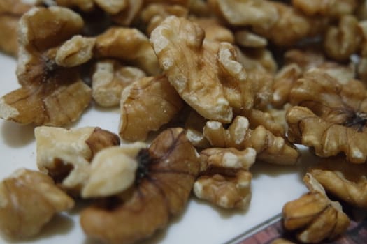 Close-up top view of peeled walnut on a white background. peeled walnut without shell ready to eat dry fruit.