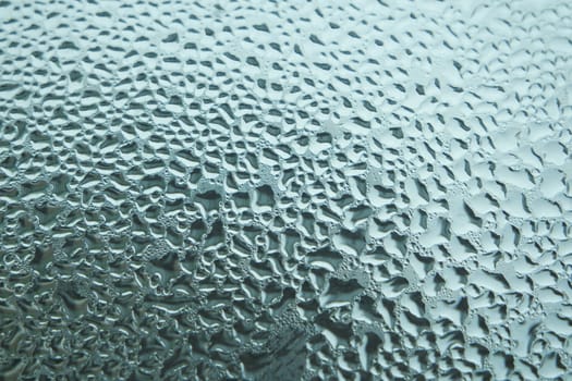 Bright grey color glassy texture, with water drops on it. Water drop glassy background