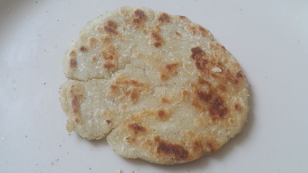 Closeup view of of traditional bread called Jawar roti or bhakri on white background. Bhakri is a round flat unleavened bread often used in the cuisine of many Asian countries