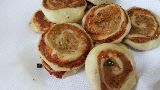 Closeup of delicious home made pinwheel puff pastries food item placed over white background