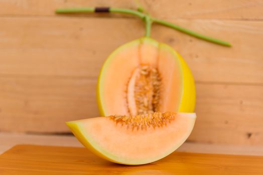 fresh golden melon on wood plate