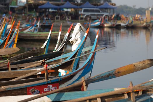 Colourful boats moored at Taungthaman Lake near Amarapura in Myanmar by the U Bein Bridge . High quality photo