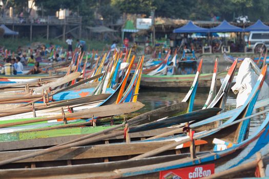 Colourful boats moored at Taungthaman Lake near Amarapura in Myanmar by the U Bein Bridge . High quality photo