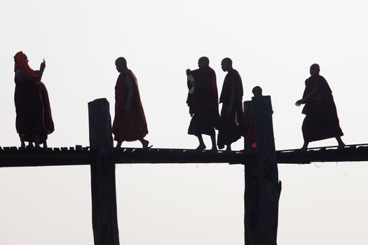 Silhouettes of local people walking on u bien bridge Mandalay, Myanmar. High quality photo