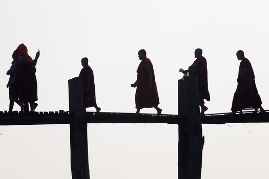 Silhouettes of local people walking on u bien bridge Mandalay, Myanmar. High quality photo