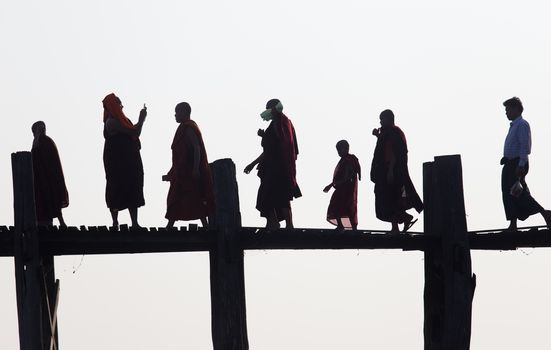 Silhouettes of local people walking on u bien bridge Mandalay, Myanmar. High quality photo