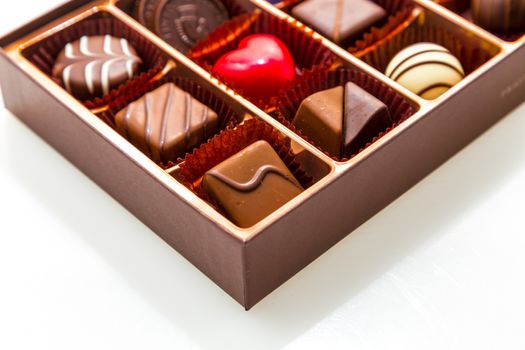 Assorted chocolates in brown box, with red heart chocolate