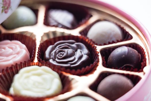 Assorted chocolates in pink box, shallow depth of field