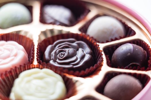 Assorted chocolates in pink box, shallow depth of field