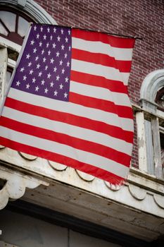 American flag in front of colonial style building