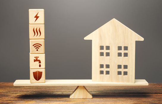 House and blocks with utilities public service symbols on scales. Availability of bill payment. Home is too big and its maintenance costs are high. Improve water and energy efficiency. Energy saving