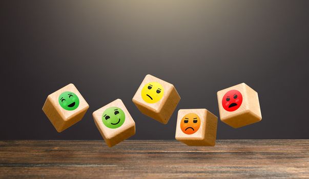 Flying blocks with faces of moods from joy to anger. Conducting a survey. Rating. Approval, indifference, or disagreement. Clients' mood, public opinion. Popularity. Assessment of people's reaction.