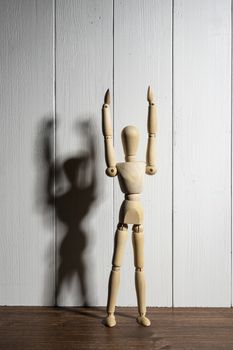 the  wooden mannequin with raised arms