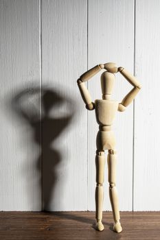 the  wooden mannequin with raised arms