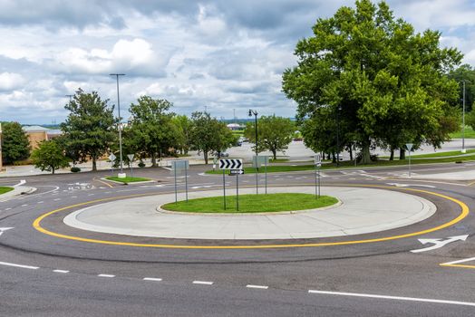 Horizontal shot of a traffic roundabout near a suburban mall.