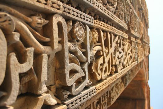 Intricate work of carvings and verses from holy Quran on the red and buff sandstone of Qutab Minar