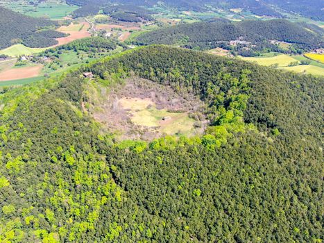 The Santa Margarida Volcano is an extinct volcano in the comarca of Garrotxa, Catalonia, Spain. The volcano has a perimeter of 2 km and a height of 682 meters in Garrotxa Volcanic Zone Natural Park