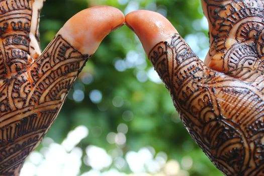 beautifully decorated indian hands with mehandi typically done for weddings