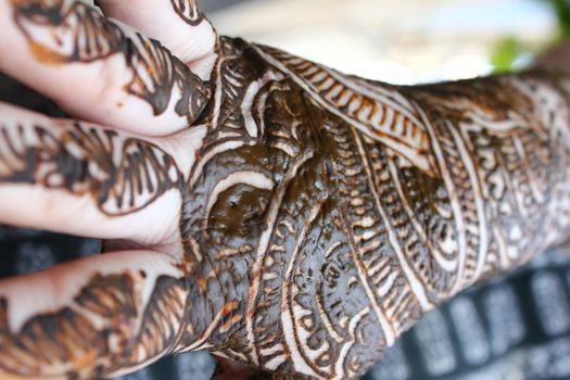 Henna is applied to the hands of a Hindu Bride