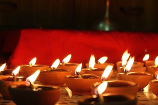 multiple oil lamps lit on diwali festival