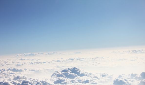 Blue sky and clouds. Plane view above the earth, can be used for background