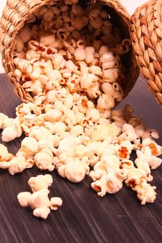 popcorn in bowl spreading on wooden block