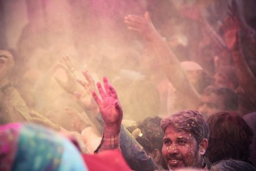 BARSANA - MAR 09: Devotees celebrate the traditional and a ritualistic Holi at Radharani temple on March 09, 2014 in Barsana, India. Holi is the most celebrated and colorful festival in India.