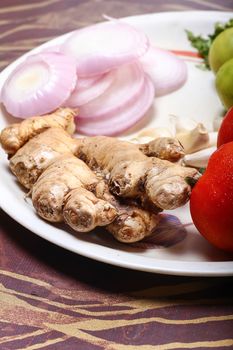 Tomato, lemon, ginger is colorful vegetable put on plate