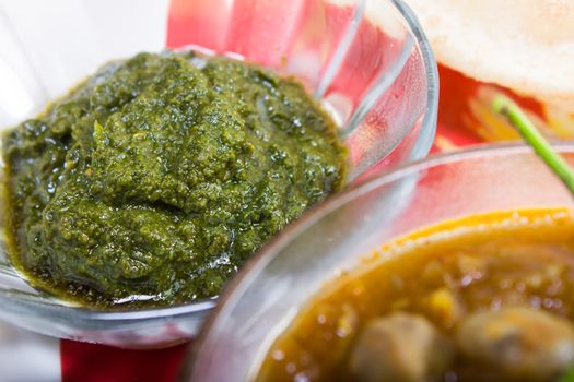 green chutney served with chickpeas and bhature
