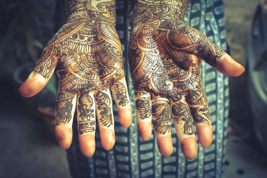 Henna is applied to the hands of a Hindu Bride